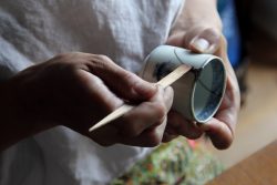 Mio Heki kintsugi repairing ceramic cup in studio Kyoto Japan close-up