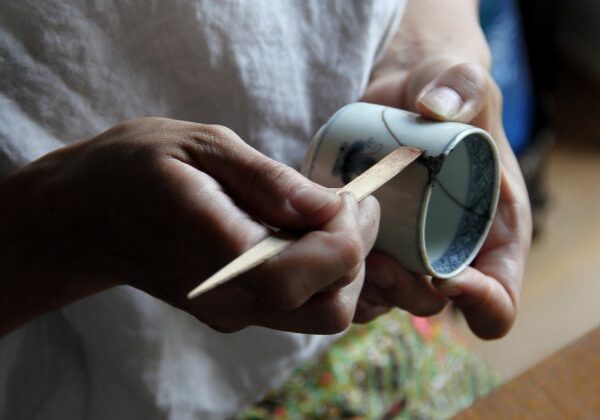 Mio Heki kintsugi repairing ceramic cup in studio Kyoto Japan close-up
